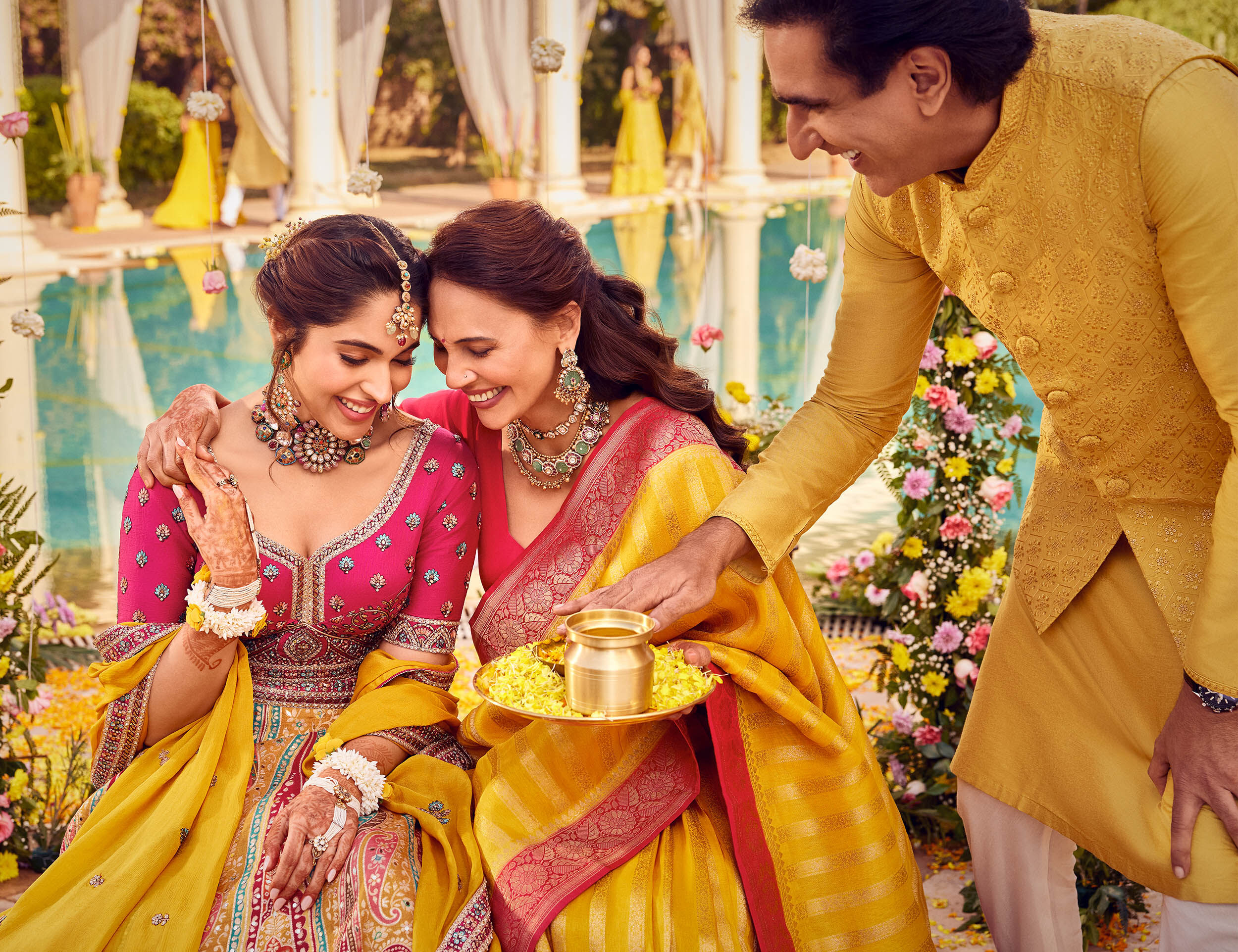 Bride wearing beautifull lehenga and mother wearing beautifull saree and father in elegant yellow kurta pajama for wedding ceremony